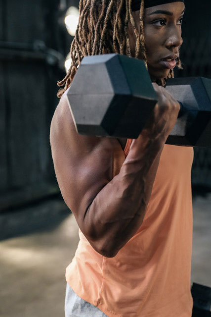 The coach is holding the dumbbell.